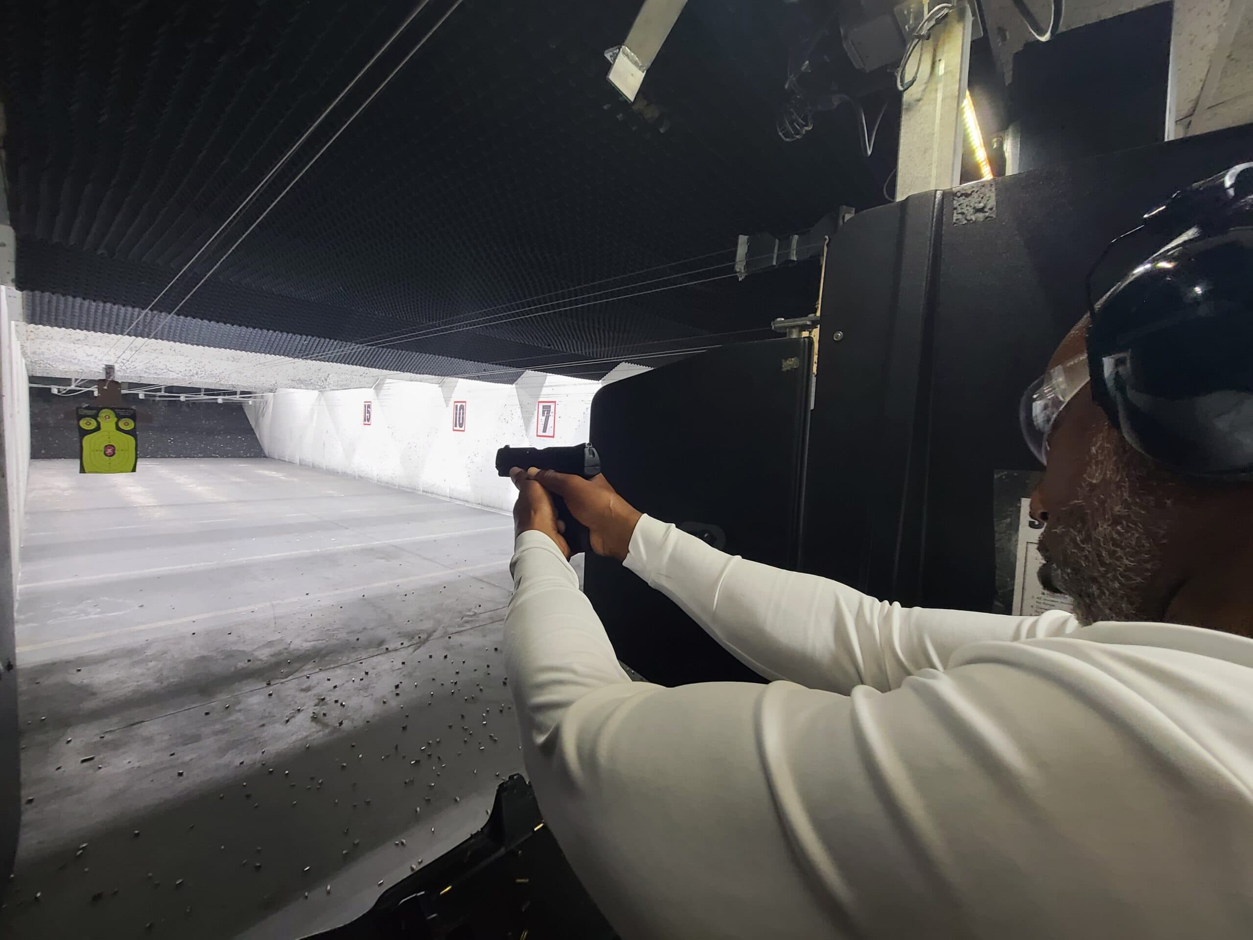 A student on the firing line at the National Safety Center range, the lane lit downrange